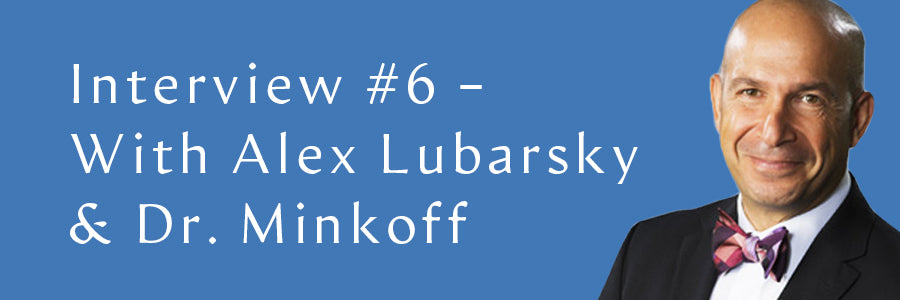 Alex Lubarsky smiling on a light blue background.