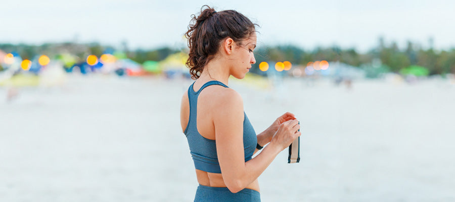 athletic woman on the beach resting after excercise 