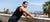 Athletic male leaning against a wall catching his breath after running