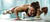 Athletic female planking and stretching