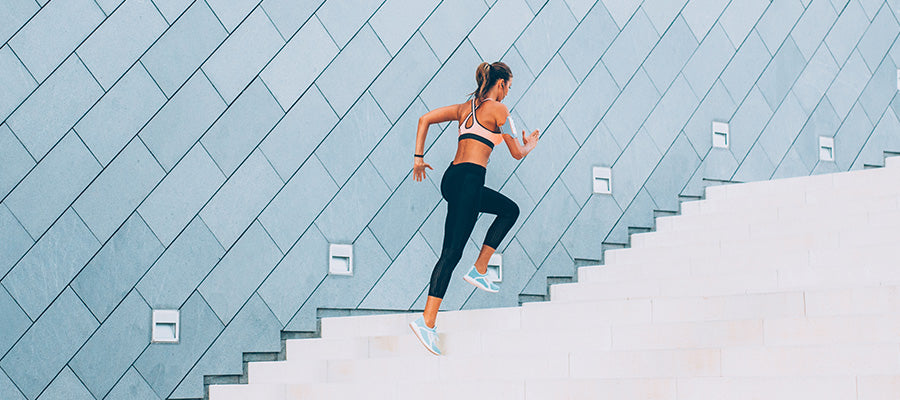 Athletic woman running up stairs for a great workout