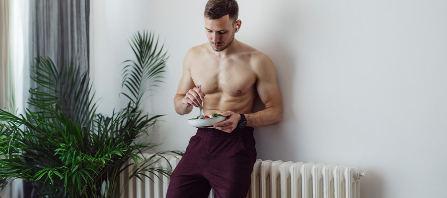 Athletic male eating some healthy food after working out