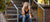 athletic woman resting on stairs after a workout enjoying a BodyHealth Bar