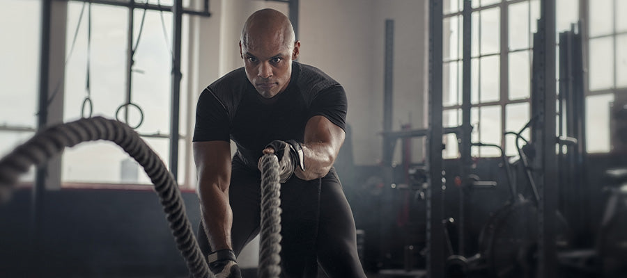 athletic man doing rope training