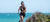 Athletic woman running on the beach.