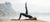 Athletic Female doing yoga by the lake