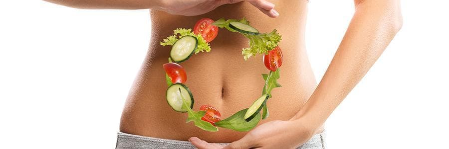 Person holding salad ingredients in a circle on their stomach.