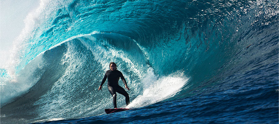 Surfer on a large wave going through the tunnel of the wave.