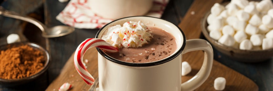 Delicious vegan sugar free hot chocolate with candy cane and whipped cream.